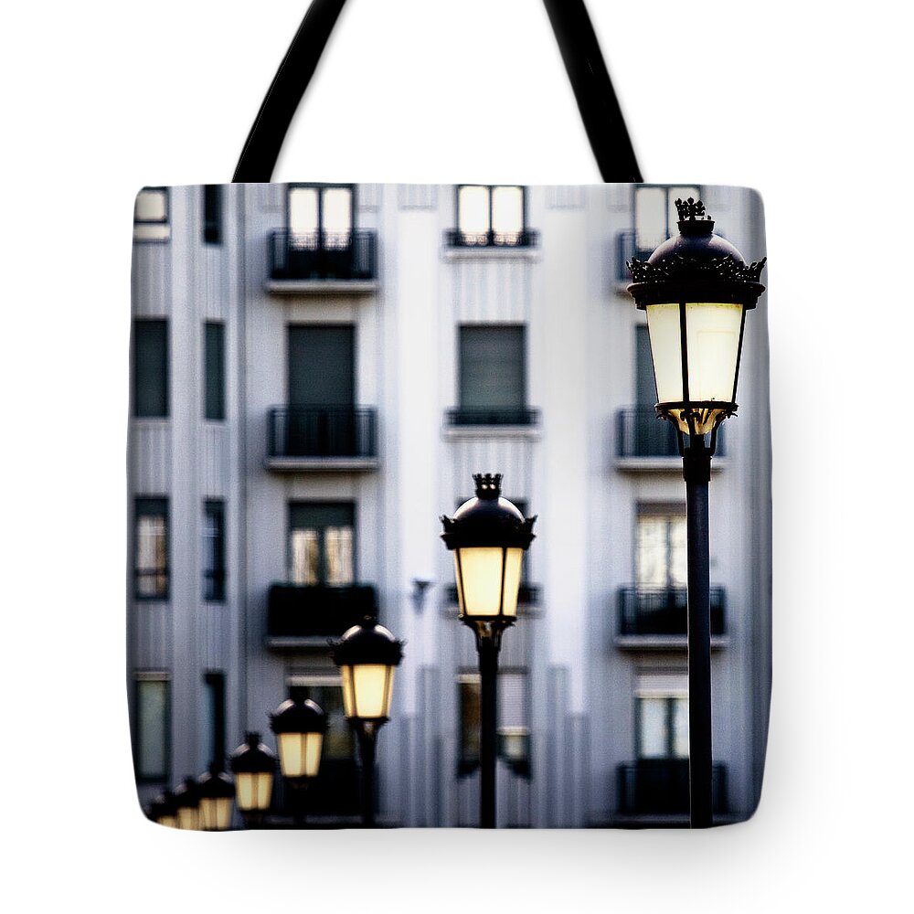 Dawn Tote Bag featuring the photograph Sun Illuminates Streetlights And Windows by Iñaki De Luis
