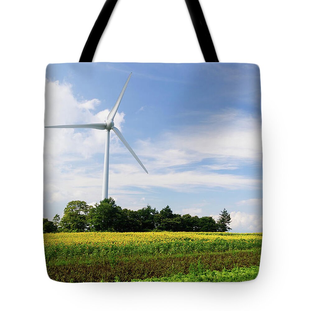 Environmental Conservation Tote Bag featuring the photograph Sunflower Field With Wind Turbines by Kwphotobox
