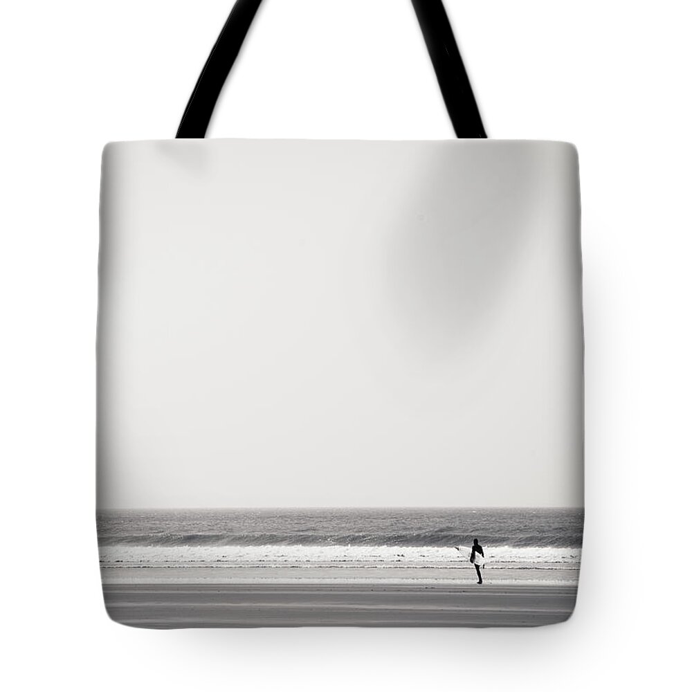 Tranquility Tote Bag featuring the photograph Surfer At Newgale Beach, Wales by Elaine W Zhao