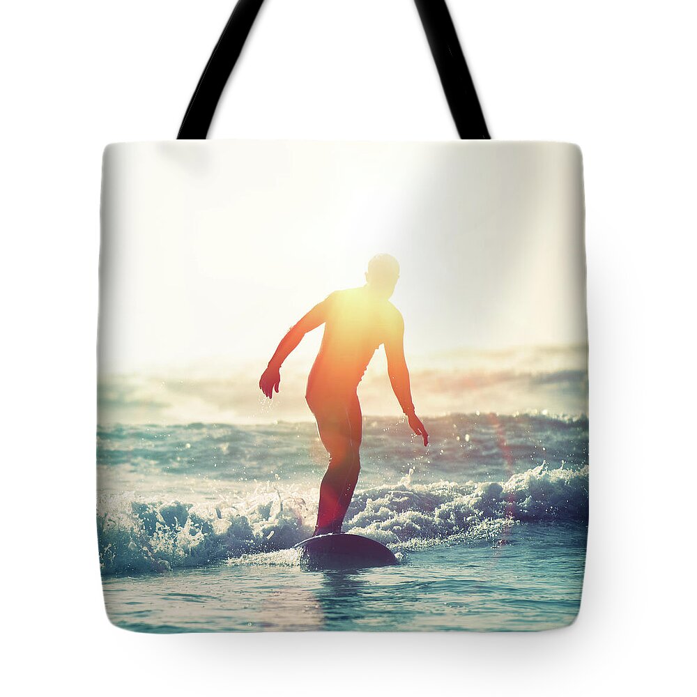 People Tote Bag featuring the photograph Surfing Sunflare by Paul Mcgee