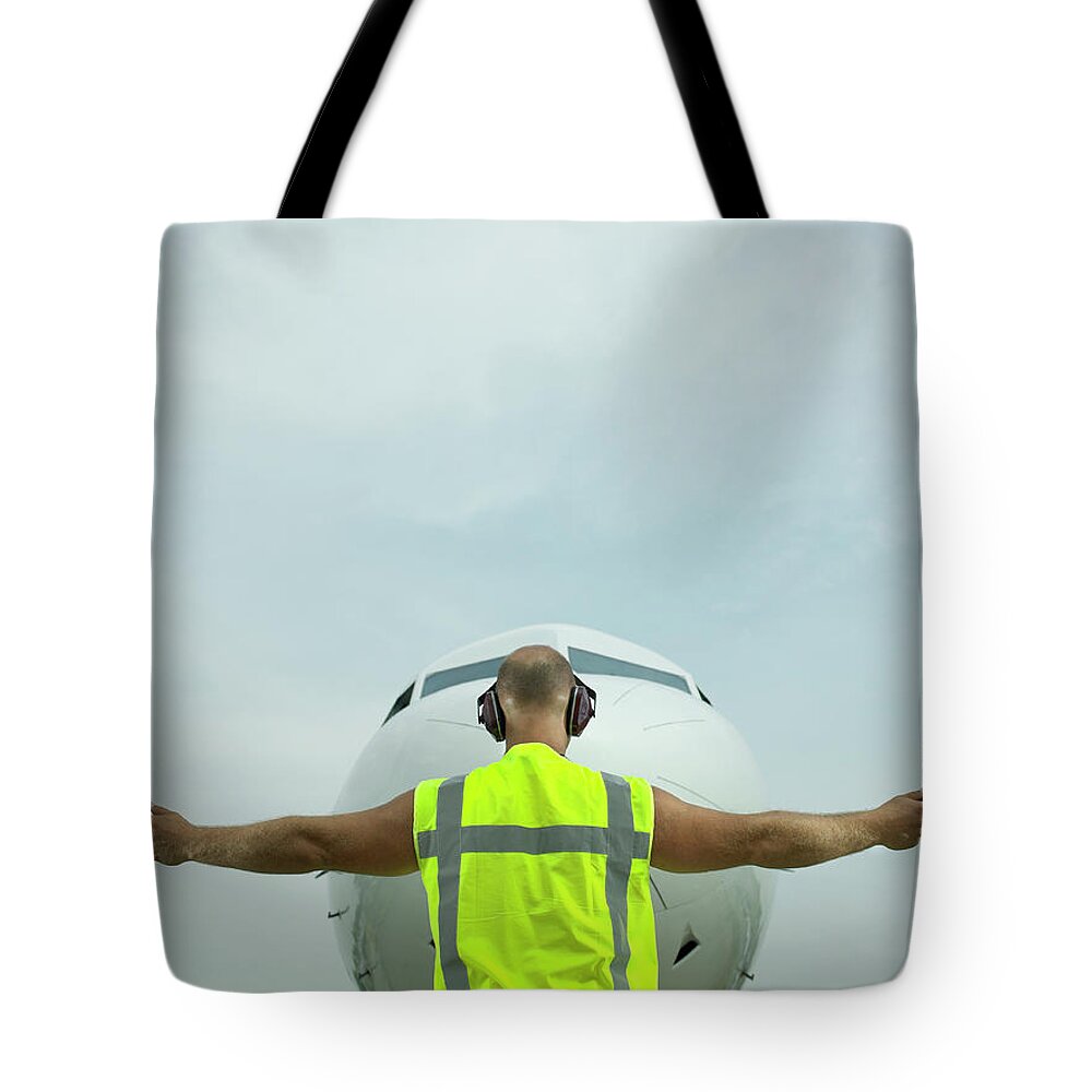 Human Arm Tote Bag featuring the photograph Technician Signalling Directions To by Hans Neleman