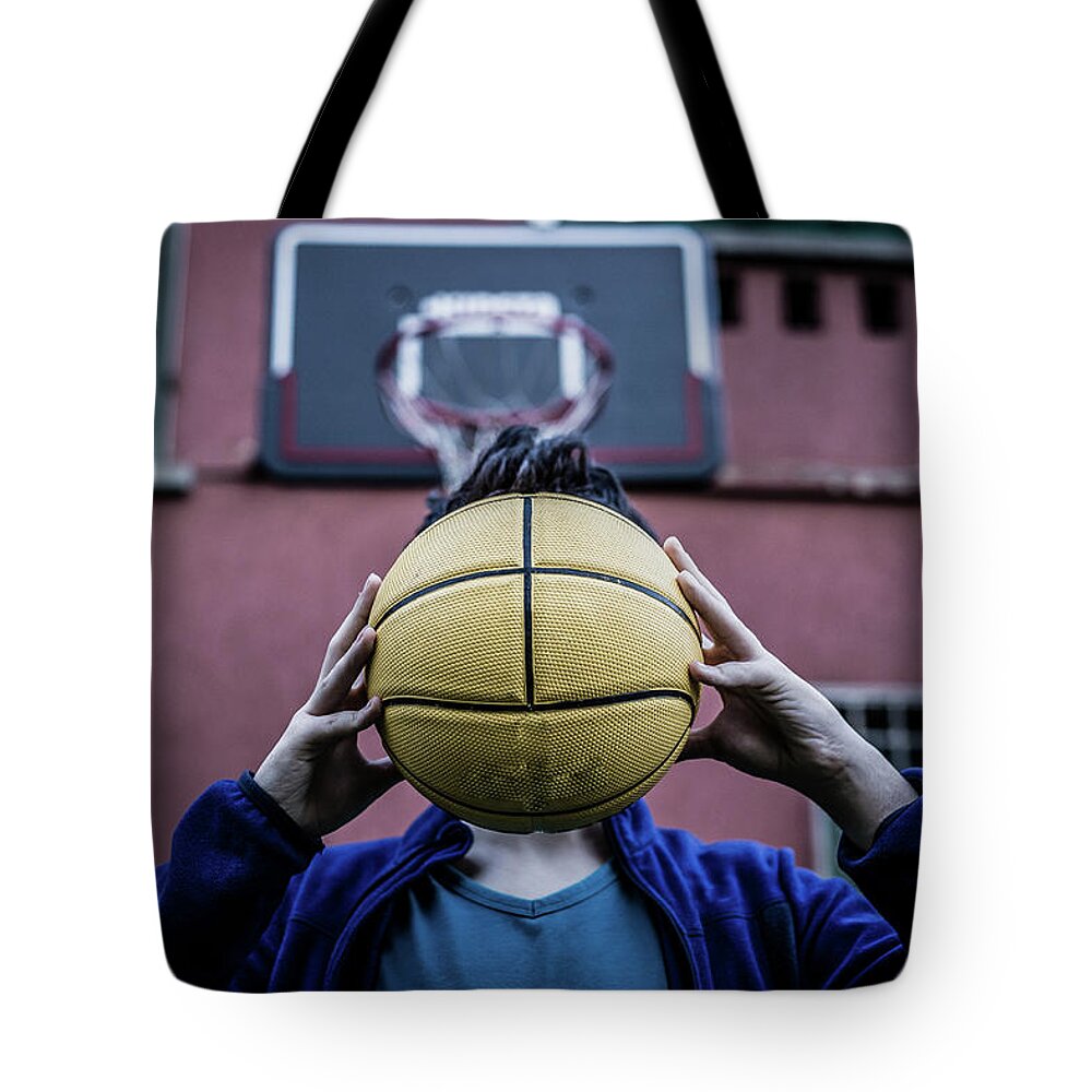 Handsome Tote Bag featuring the photograph Teenager Holding Ball by Vivida Photo PC