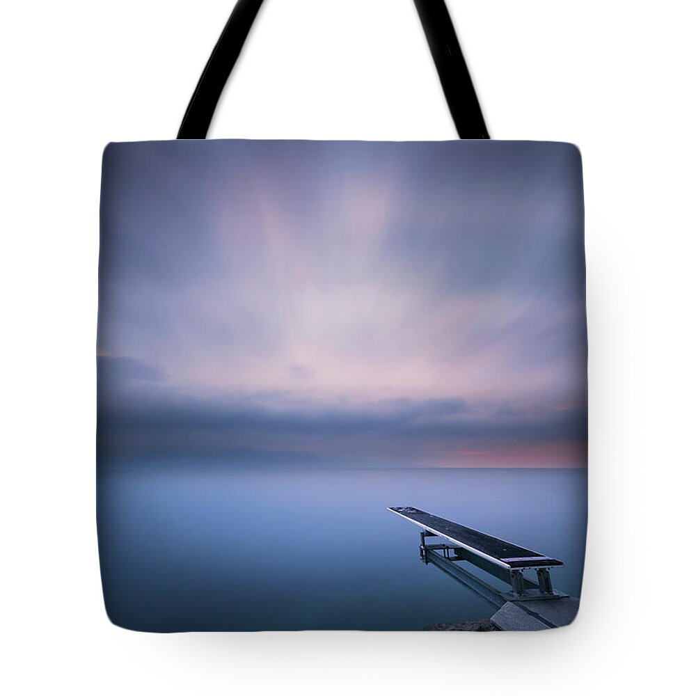 Sunrise Tote Bag featuring the photograph The evening dive by Dominique Dubied