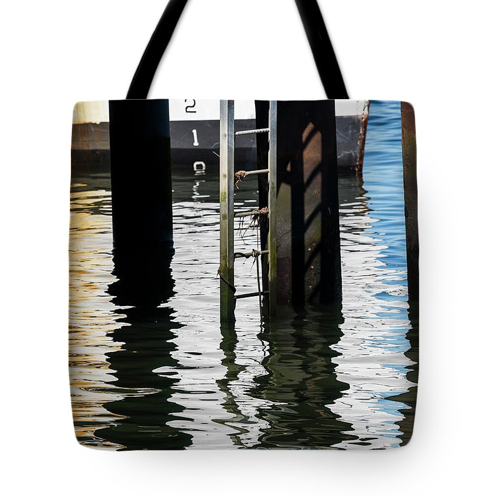17th Street Dock Tote Bag featuring the photograph The Lower Rungs by Robert Potts