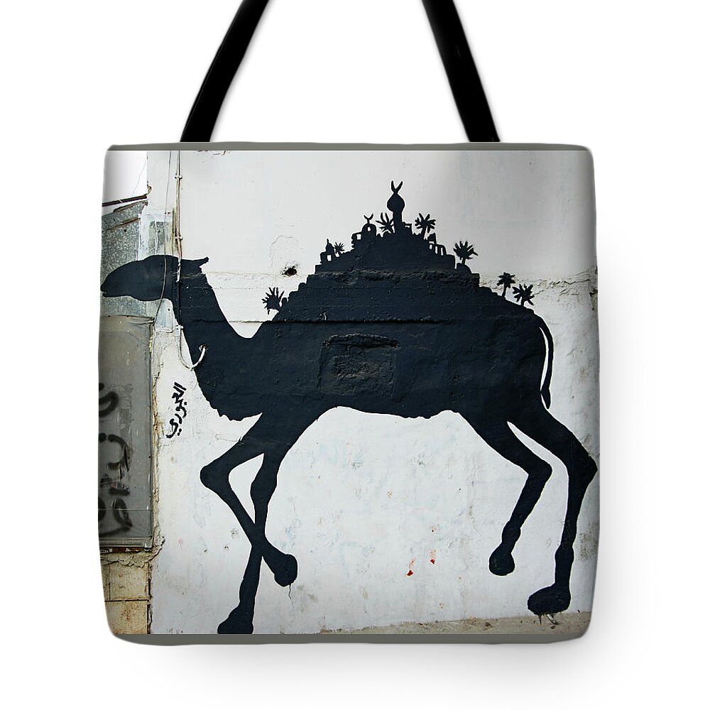 Refugee Camp Tote Bag featuring the photograph The Refugee Camp Camel by Munir Alawi