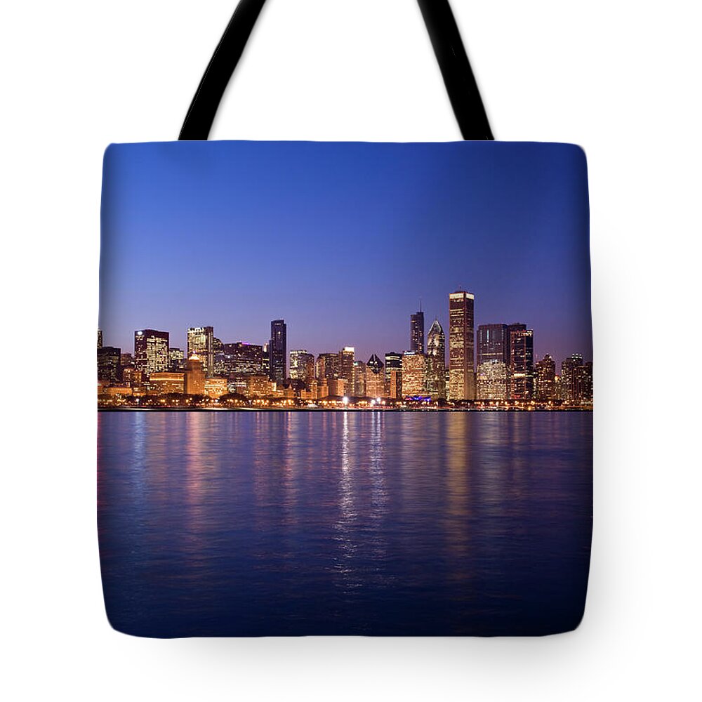 Lake Michigan Tote Bag featuring the photograph The Skyline At Night In Chicago by Bookwyrmm