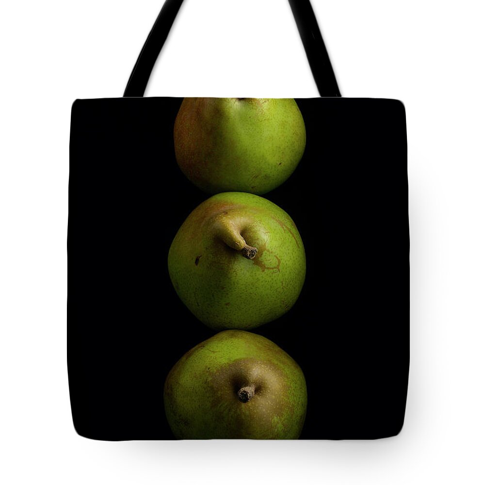 Three Anjou Pears On A Black Surface Tote Bag by Howard Bjornson