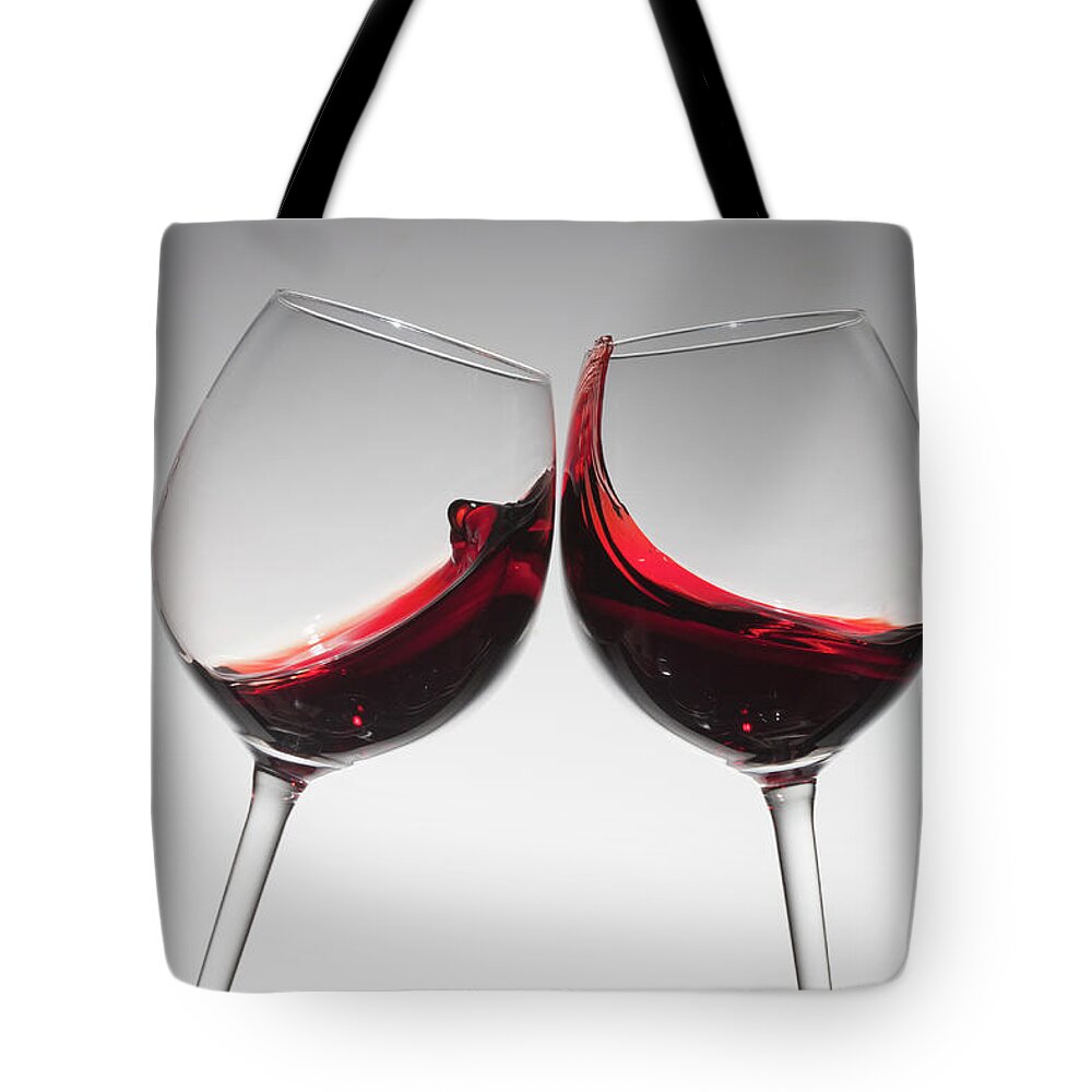 Alcohol Tote Bag featuring the photograph Toasting With Two Glasses Of Red Wine by Dual Dual