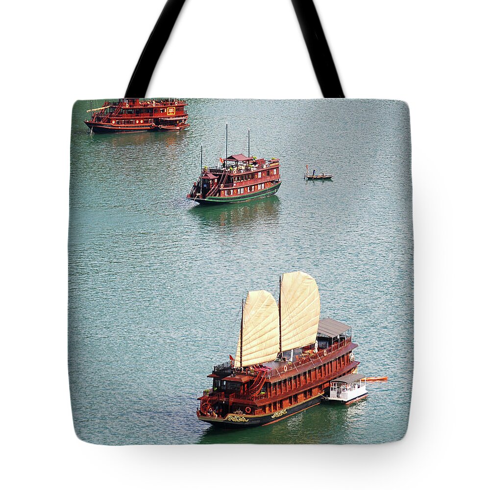 Seascape Tote Bag featuring the photograph Tourist wooden Boats at Halong Bay Vietnam by Michalakis Ppalis