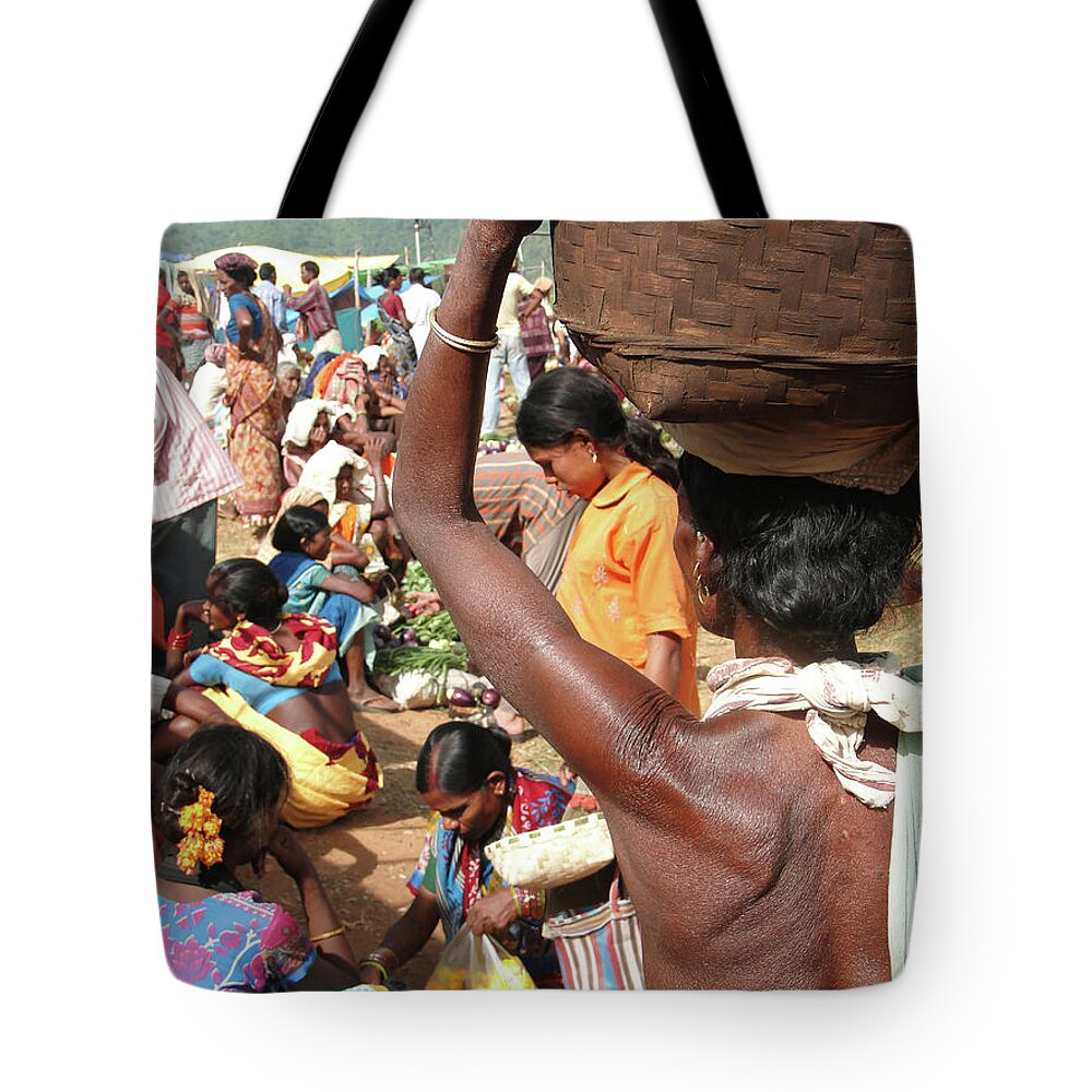 Women Tote Bag featuring the photograph Tribal women carry goods on their heads by Steve Estvanik