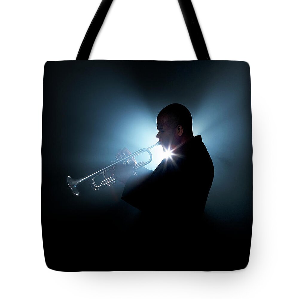 People Tote Bag featuring the photograph Trumpeter Playing Horn On Stage by Tooga