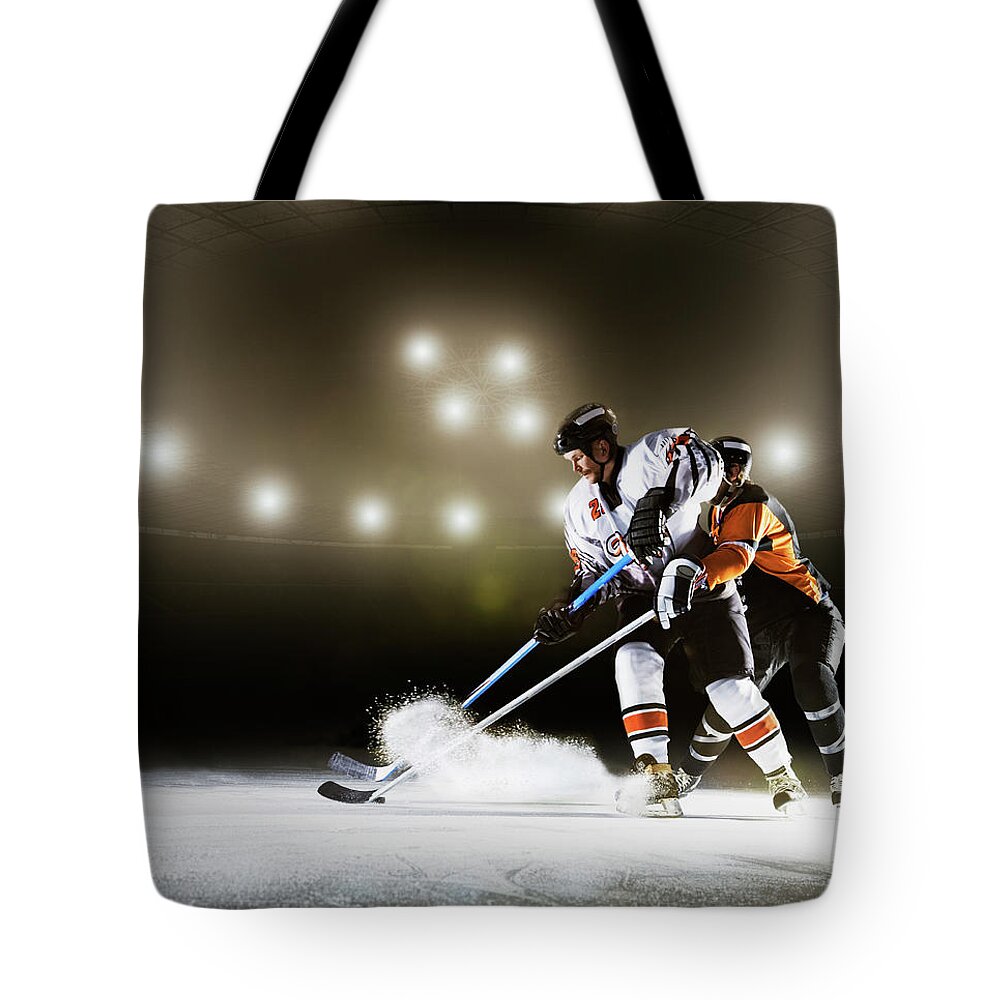 Sports Helmet Tote Bag featuring the photograph Two Ice Hockey Players Competing For by Robert Decelis Ltd