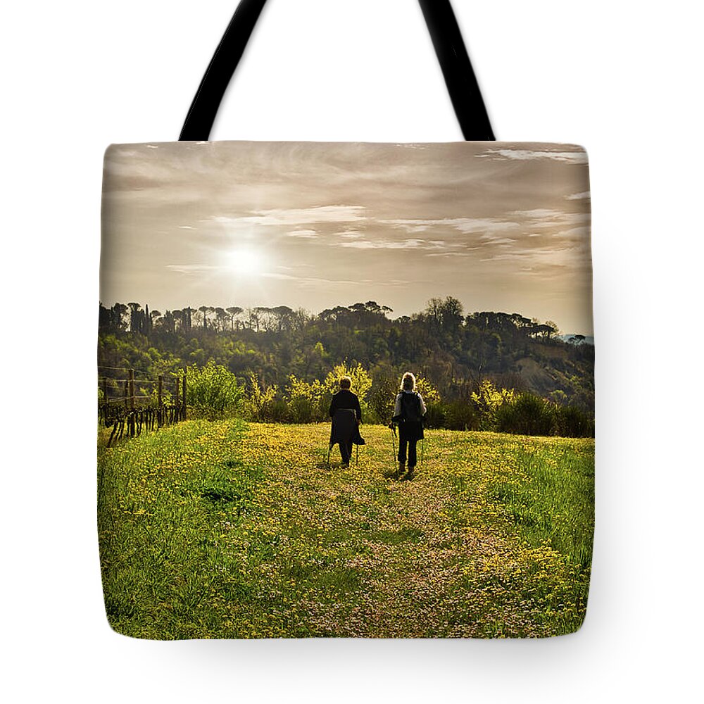 Italy Tote Bag featuring the photograph Two Women Hiking Together In Nature by Vivida Photo PC