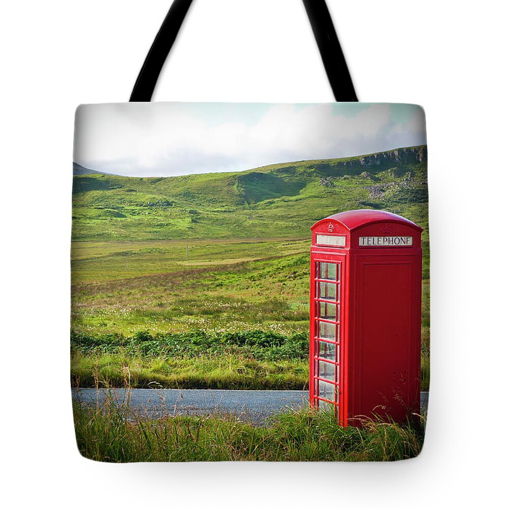 Bench Tote Bag featuring the photograph Typical red English telephone box in a rural area near a road. by Joaquin Corbalan