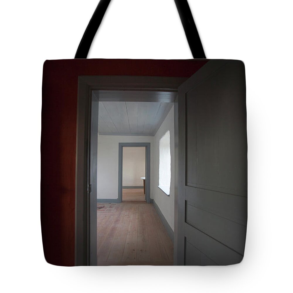 Tranquility Tote Bag featuring the photograph View Of Empty Room Through Door by Johner Images