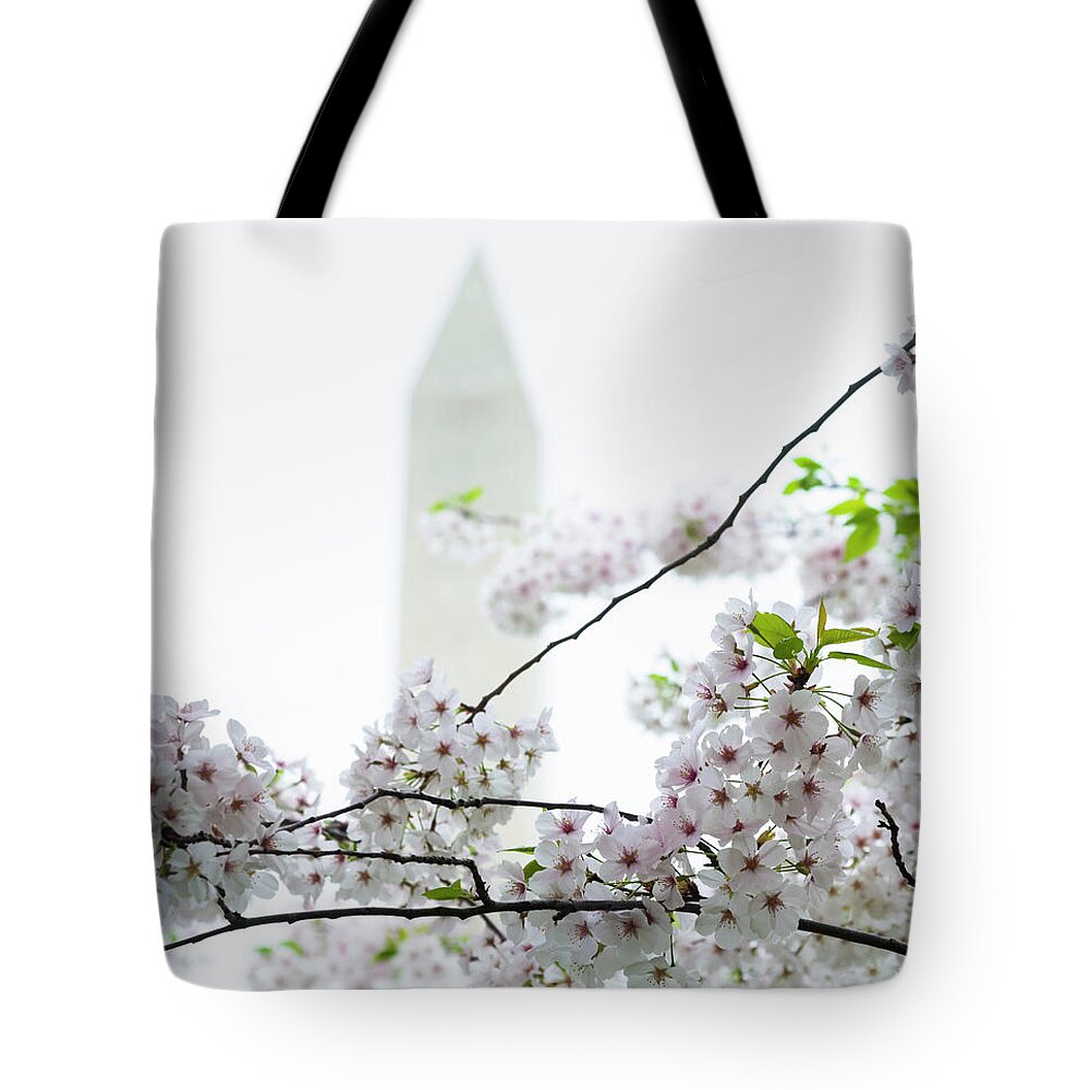 Tidal Basin Tote Bag featuring the photograph Washington Monument With Cherry Blossoms by Drnadig