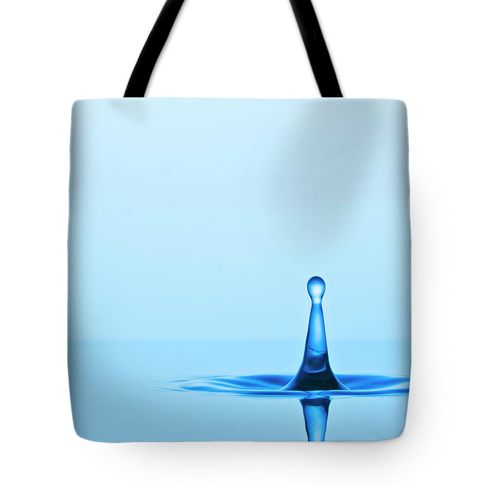 Emergence Tote Bag featuring the photograph Water Drop Rebounding by Kim Westerskov