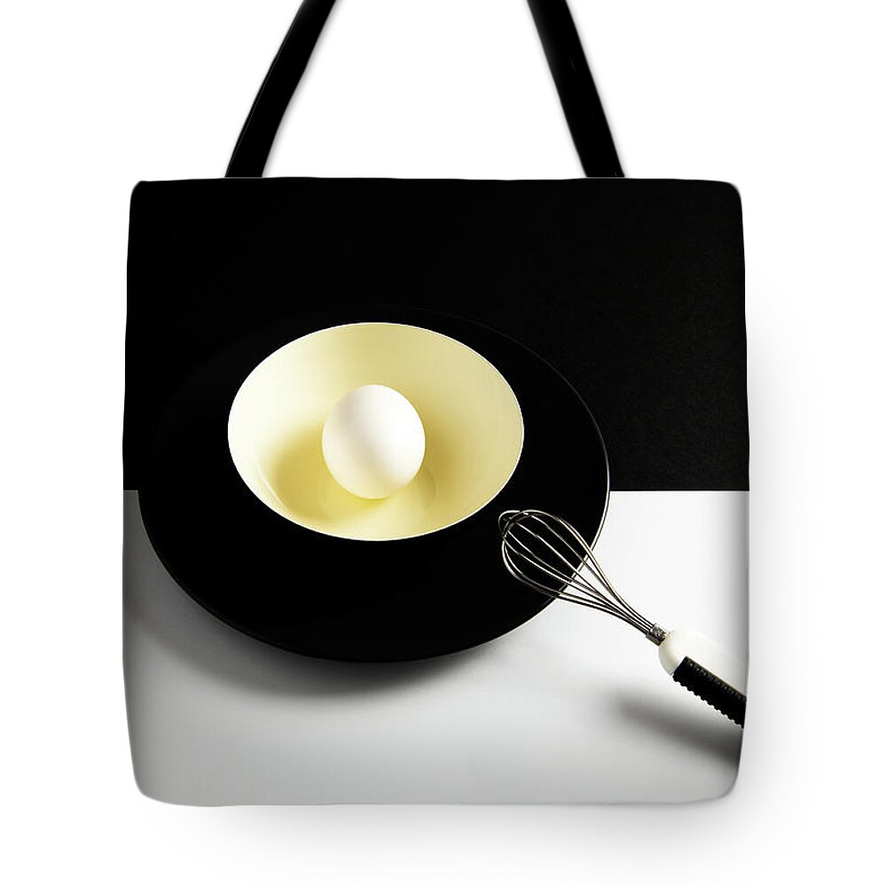 Egg Tote Bag featuring the photograph White egg on a yellow bowl. by Michalakis Ppalis