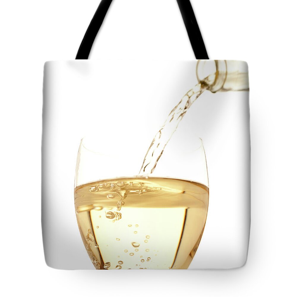 White Background Tote Bag featuring the photograph White Wine Pouring Into A Glass by Ross Durant Photography