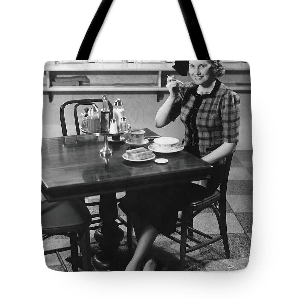 Breakfast Tote Bag featuring the photograph Woman In Fancy Hat Eating Breakfast In by George Marks