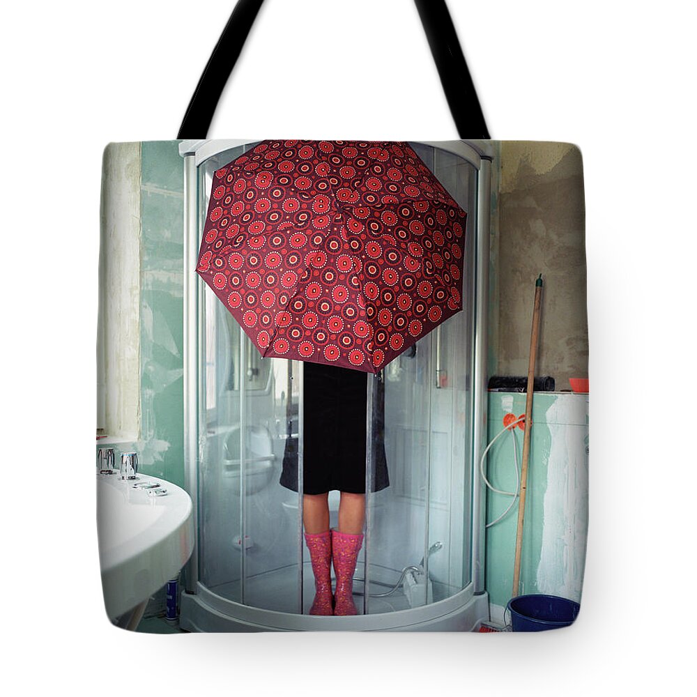Sequential Series Tote Bag featuring the photograph Woman Standing Under Umbrella In Shower by Silvia Otte