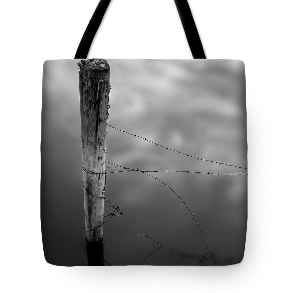 Wooden Post Tote Bag featuring the photograph Wooden Post With Barbed Wire by Peter Levi