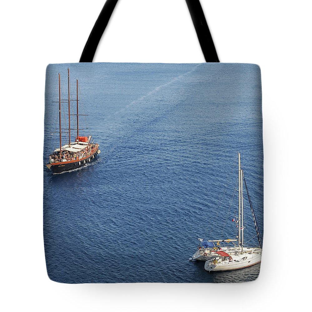 Sailing Tote Bag featuring the photograph Yachts sailing on a blue calm sea by Michalakis Ppalis