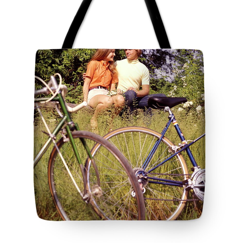 Heterosexual Couple Tote Bag featuring the photograph Young Adults Teenagers Field Date Bikes by H. Armstrong Roberts