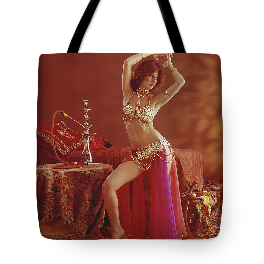 Human Arm Tote Bag featuring the photograph Young Belly Dancer Dancing Beside by Tom Kelley Archive