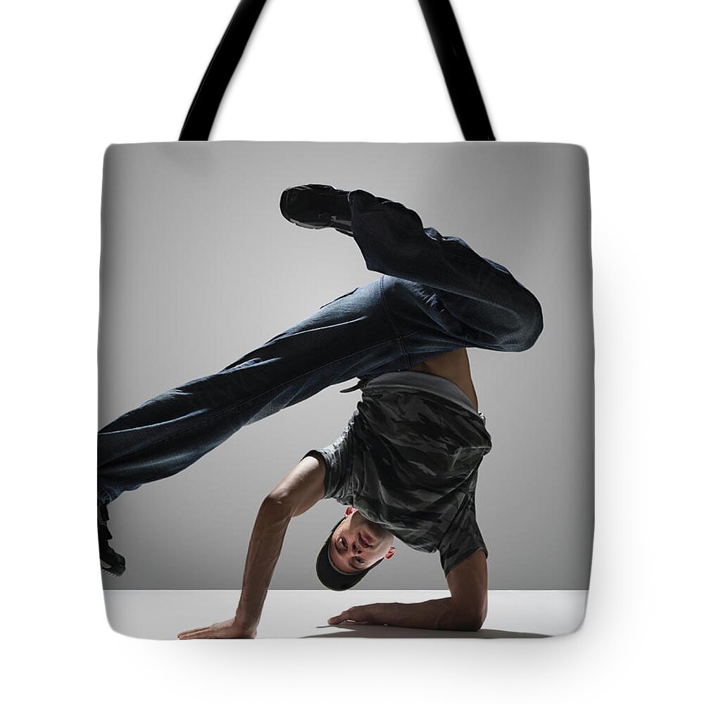 Shadow Tote Bag featuring the photograph Young Man Break Dancing by John Lamb