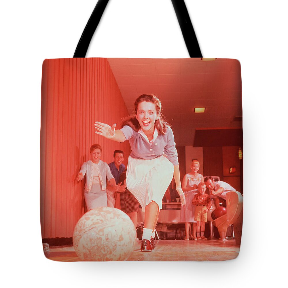 People Tote Bag featuring the photograph Young Woman Bowling, Family Watching In by Fpg