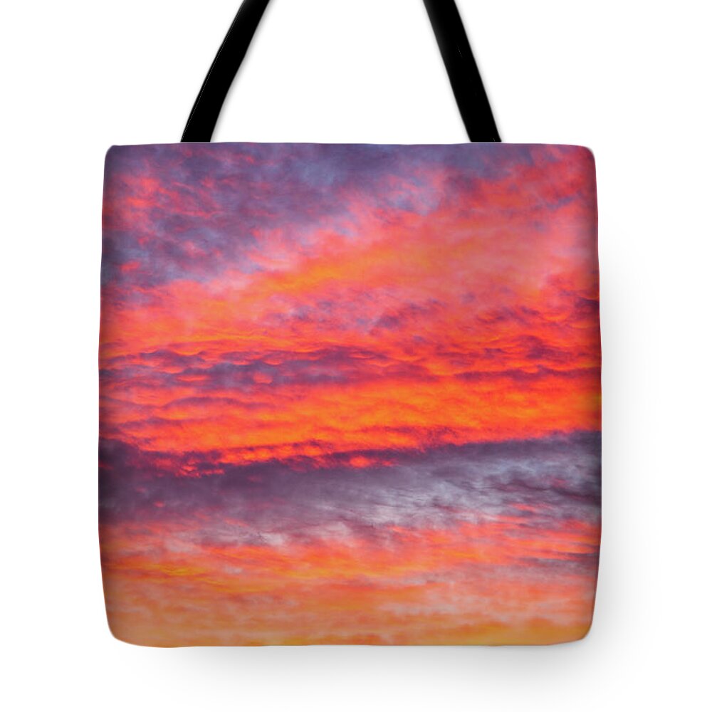 Colorful Tote Bag featuring the photograph Colorful cloudscape at sunset by Fabiano Di Paolo