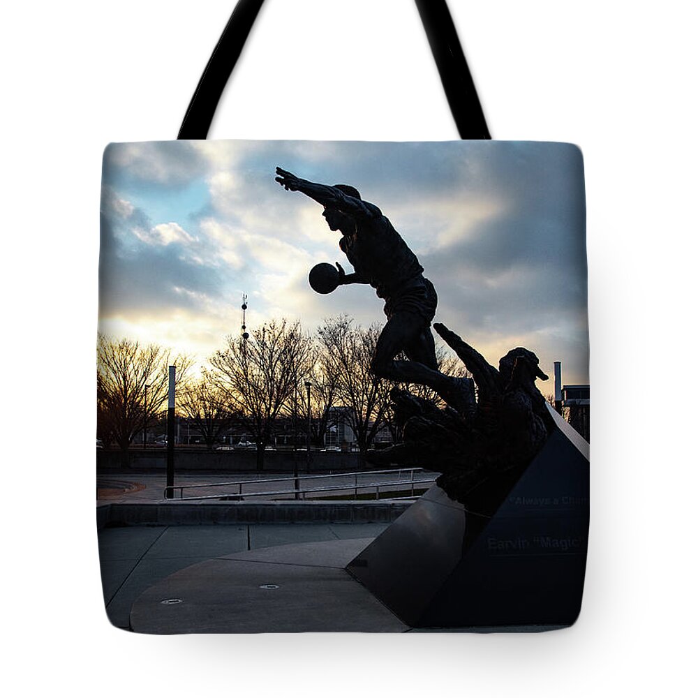 Msu Spartans Tote Bag featuring the photograph Earvin Magic Johnson statue at sunset at Michigan State University #1 by Eldon McGraw