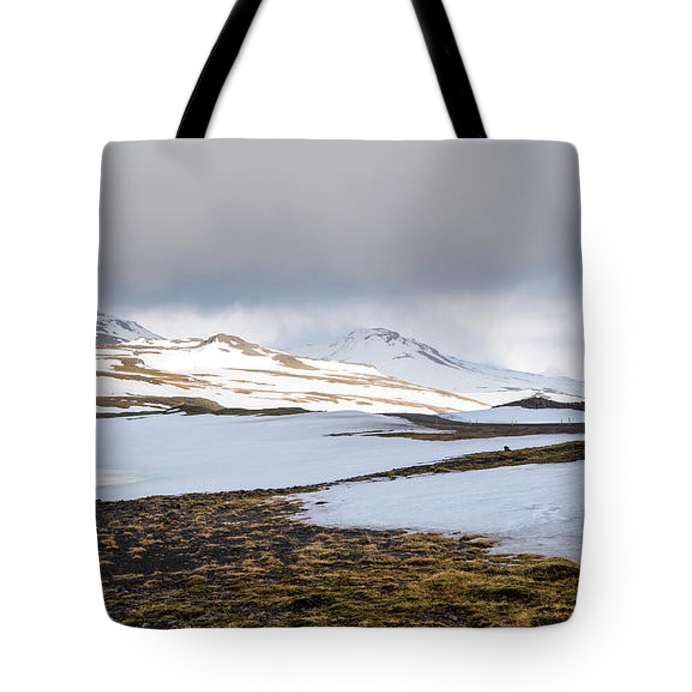 Iceland Tote Bag featuring the photograph Icelandic landscape with mountains and meadow land covered in snow. Iceland by Michalakis Ppalis