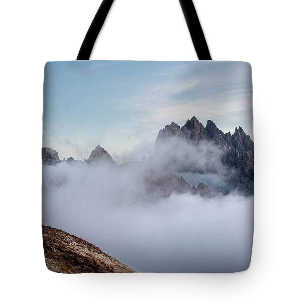 Italian Alps Tote Bag featuring the photograph Mountain landscape with fog in autumn. Tre Cime dolomiti Italy. by Michalakis Ppalis