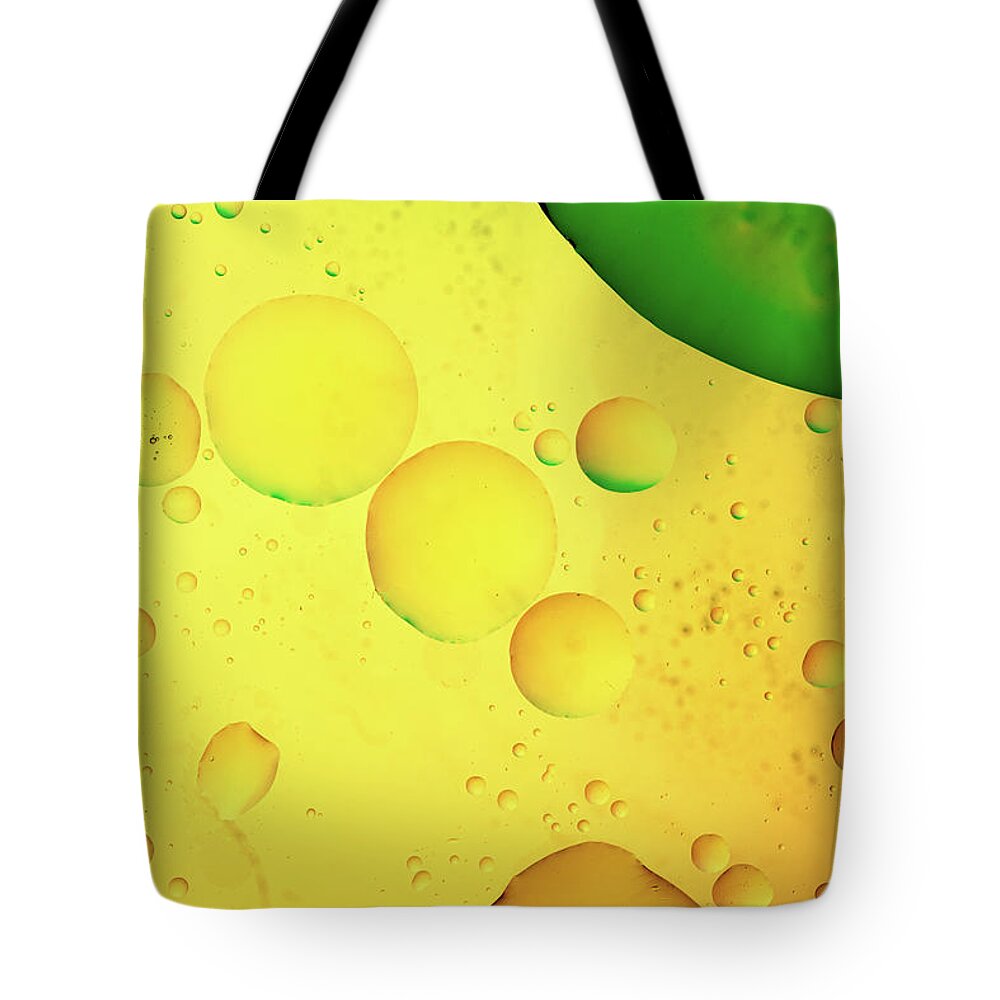 Fluid Tote Bag featuring the photograph Abstract, image of oil, water and soap with colourful background by Michalakis Ppalis
