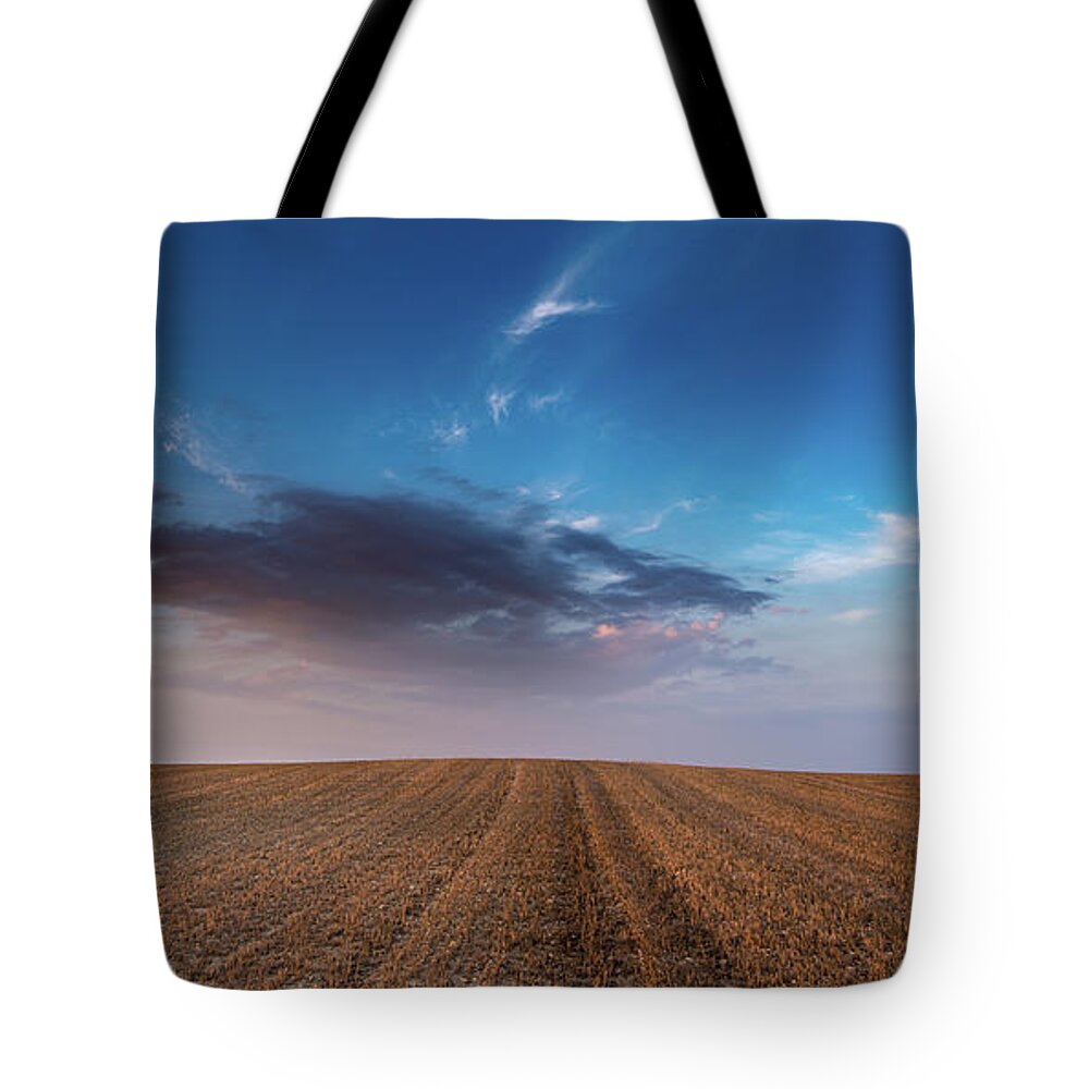 Nightfall Tote Bag featuring the photograph Agricultural meadow field and cloudy sky during sunset. #3 by Michalakis Ppalis