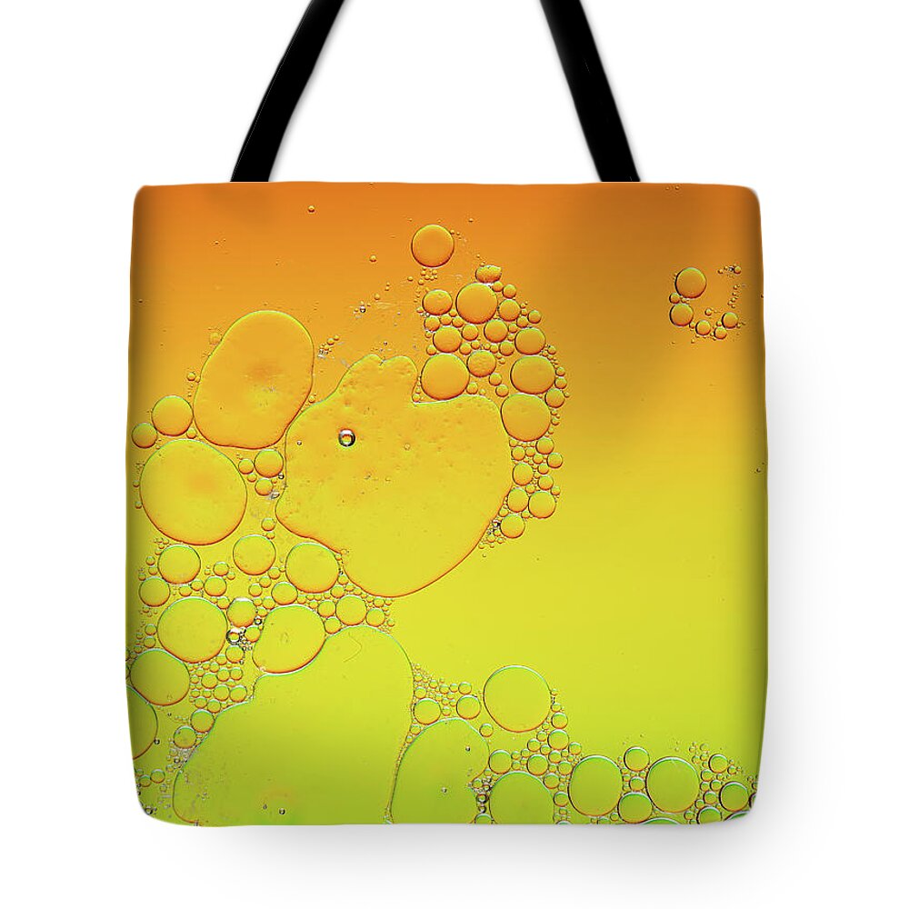 Connection Tote Bag featuring the photograph Bright abstract, yellow background with flying bubbles by Michalakis Ppalis