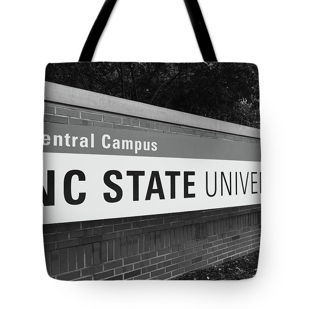 College Tour Tote Bag featuring the photograph North Carolina Statue University entrance sign in black and white #2 by Eldon McGraw