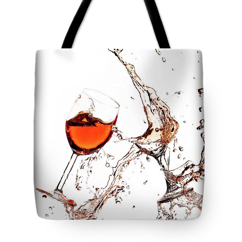 Damaged Tote Bag featuring the photograph Broken wine glasses with wine splashes on a white background by Michalakis Ppalis