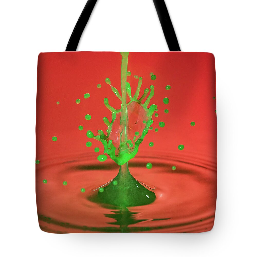 Waterdrop Tote Bag featuring the photograph Water drop falling onto column of water by Steven Heap