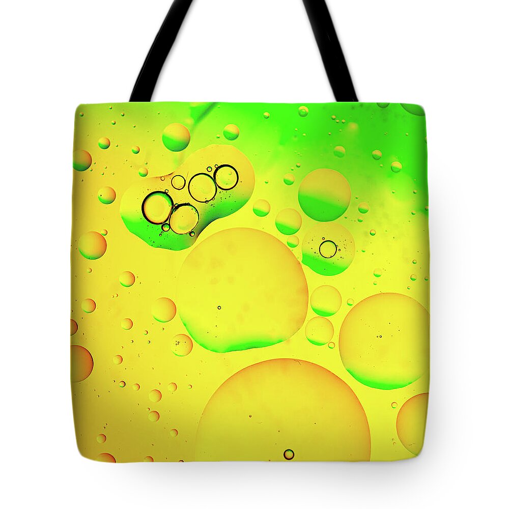 Fluid Tote Bag featuring the photograph Abstract, image of oil, water and soap with colourful background #5 by Michalakis Ppalis