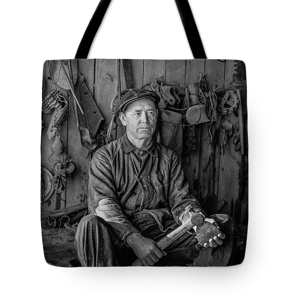 1937 Tote Bag featuring the photograph A farmer in his toolhouse by David Letts