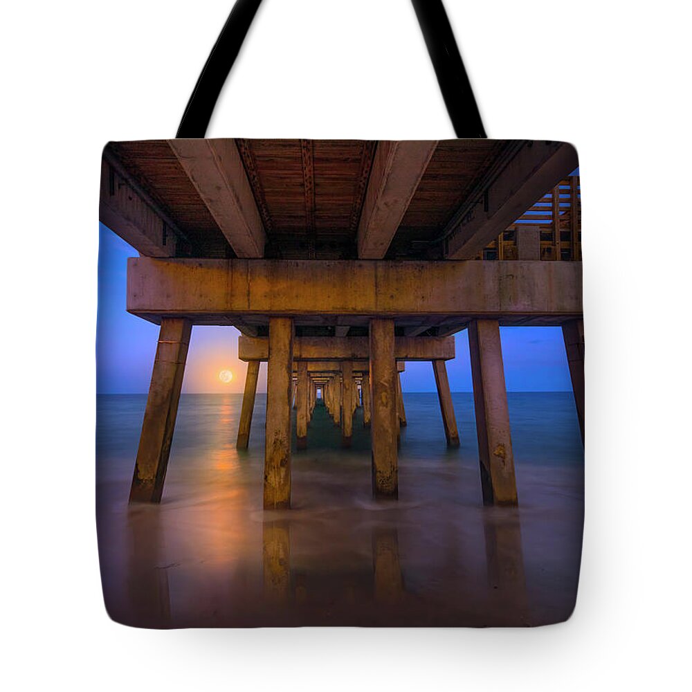 Moon Tote Bag featuring the photograph A Moonrise Under the Pier by Mark Andrew Thomas