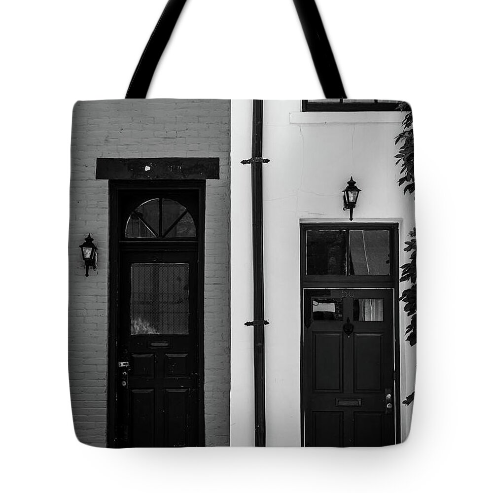 Black And White Tote Bag featuring the photograph A Pair of NYC Doors in Black and White by Liz Albro
