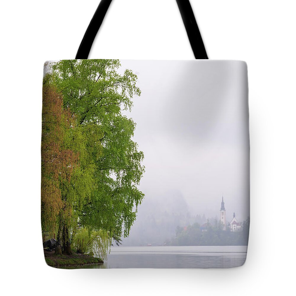 Slovenia Tote Bag featuring the photograph A rainy day in Bled, Slovenia by Mirko Chessari