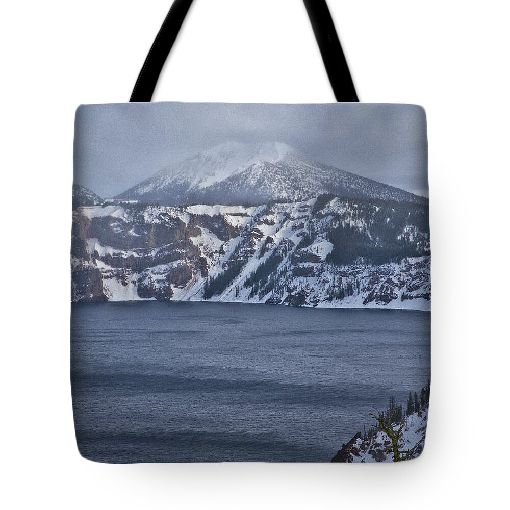 Crater Lake Tote Bag featuring the photograph A Snowy Day at Crater Lake by Tom Kelly
