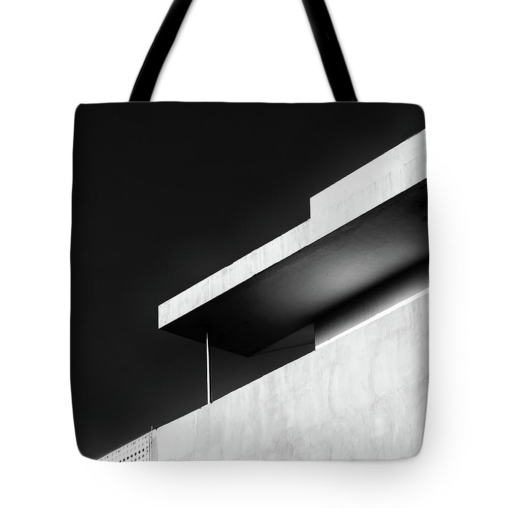 Black And White Tote Bag featuring the photograph Abstract architecture design. Black and white futuristic exterior background. Black sky copy-space by Michalakis Ppalis