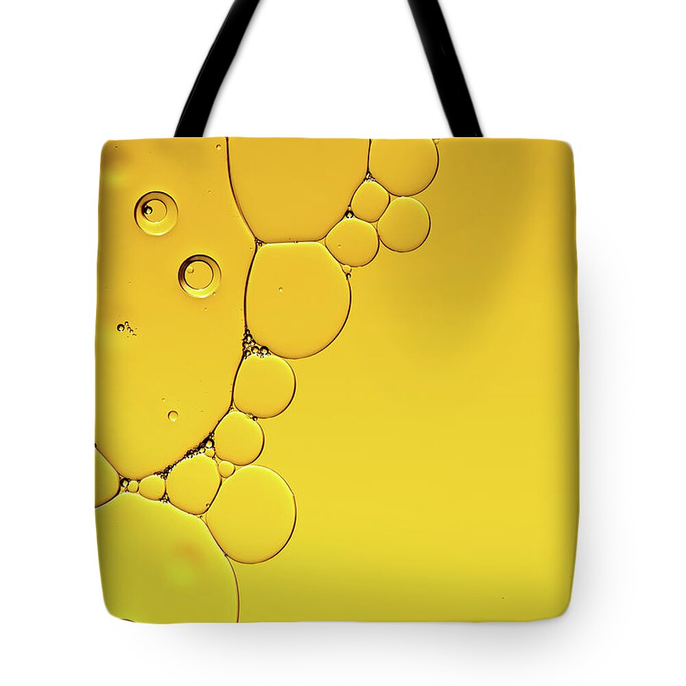 Fluid Tote Bag featuring the photograph Abstract, image of oil, water and soap with colourful background by Michalakis Ppalis