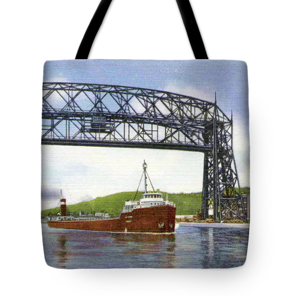 Duluth Tote Bag featuring the photograph Aerial Lift Bridge with Freighter by Zenith City Press